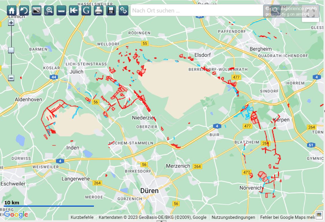 Eine detaillierte Karte, die verschiedene Routen und Gebiete in und um Jülich, Deutschland, mit markierten Wegen in Rot zeigt.